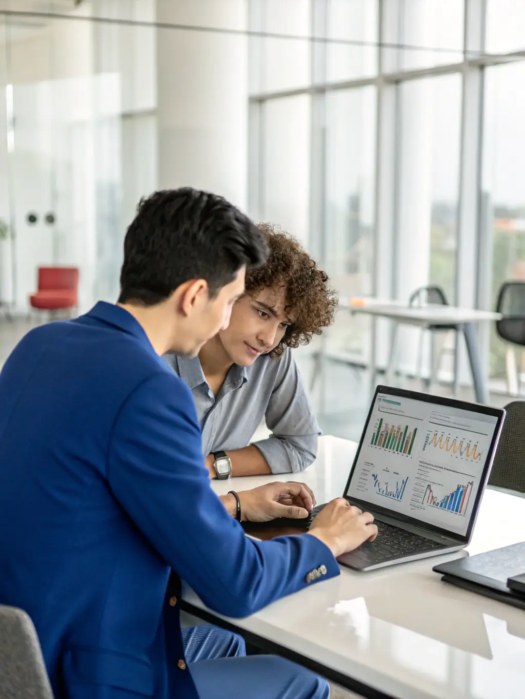An image of a marketing consultant analysing digital marketing metrics on a screen with a client.